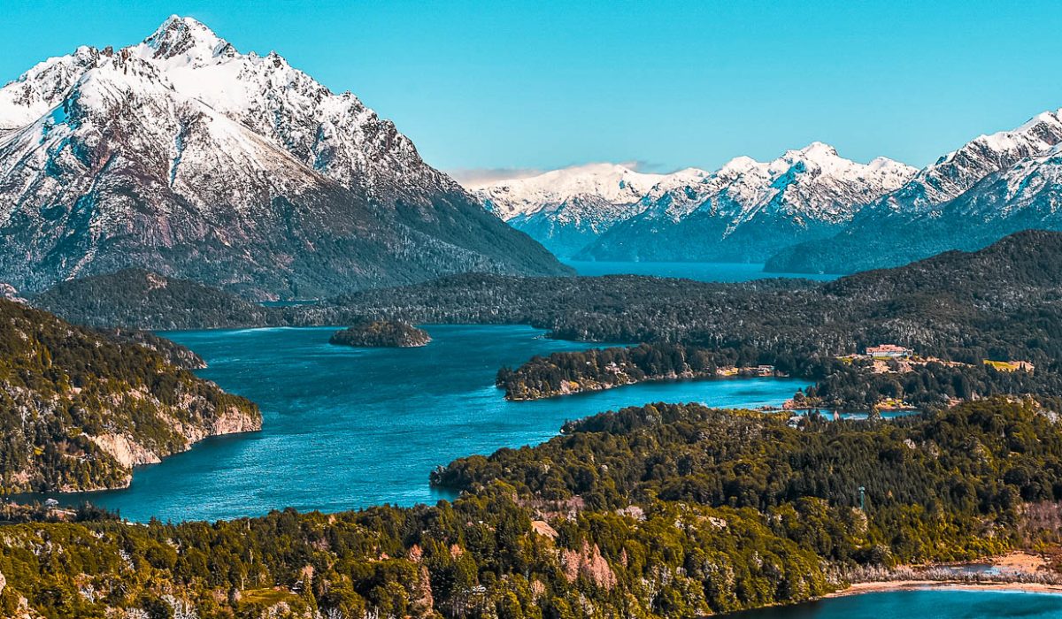 View of beautiful landscape of snowy mountains and green trees from Cerro Campanario (Campanario Hill) in San Carlos de Bariloche, Rio Negro, Patagonia Argentina. Llao Llao Hotel to the right.